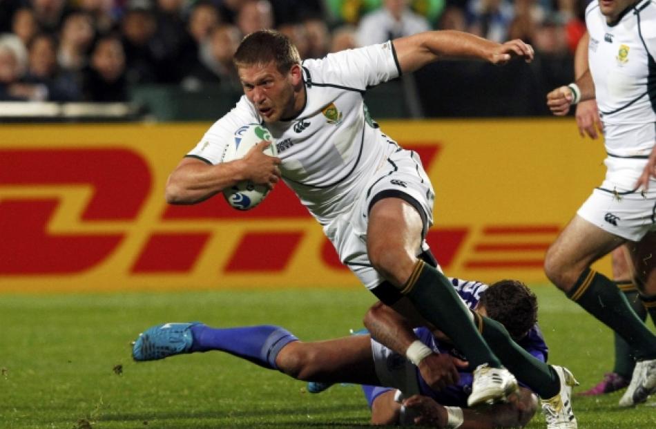 South Africa Springboks' Frans Steyn (centre) shakes off a tackle by Samoa captain Mahonri...