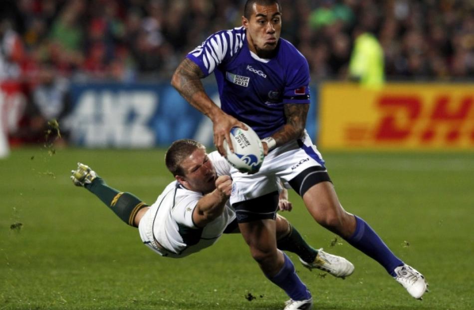 South Africa Springboks' Frans Steyn (left) tackles Samoa's Tusi Pisi during their Rugby World...