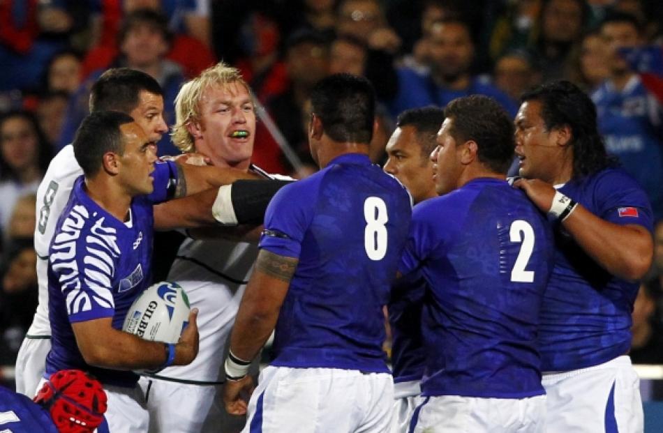 South Africa Springboks' Schalk Burger (third from left) tussles with Samoa players during their...