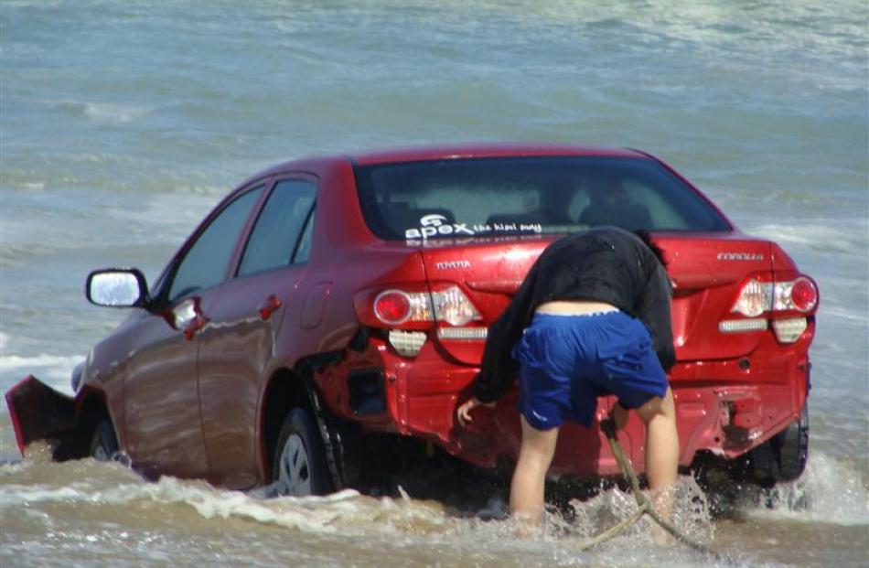 The ocean claims a car on Katiki Beach on Thursday. Photos by Trevor Lewis.