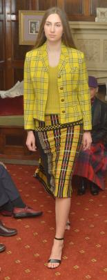 Grace Roseler, from Aart Model Management, wears  an asymmetric yellow plaid skirt, knit jumper...