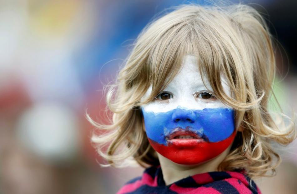 A young Russia supporter waits for the match to start. Photo: REUTERS/Brandon Malone