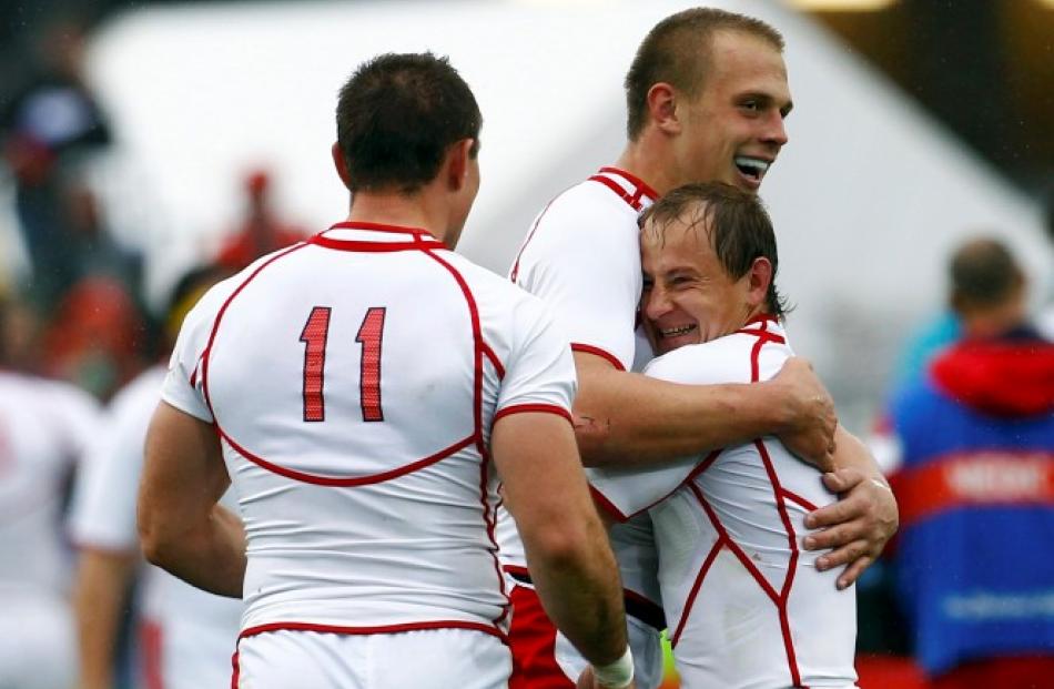 Russia's Denis Simplikevich (C) celebrates with Alexander Yanyushkin after scoring a try. Photo:...