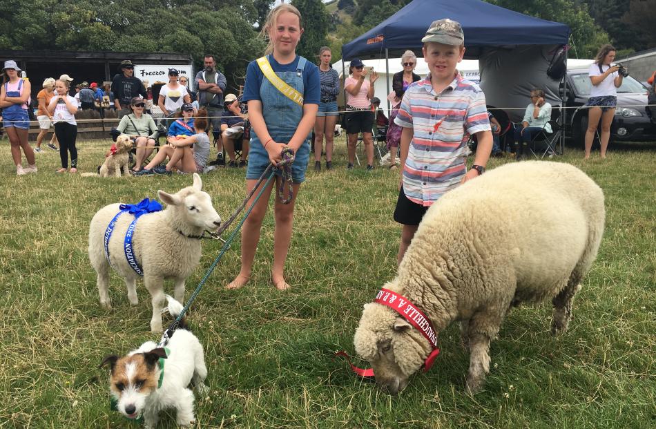 Georgia (11, left) and Will Vogan (9), of Duvauchelle, lead their pet lambs and dog during the...