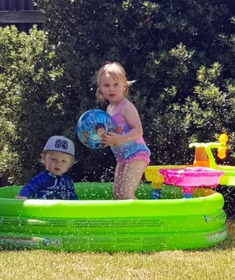 Bentley Aitkenhead (20 months) and Penelope Bell (3) enjoy some fun in the paddling pool during...