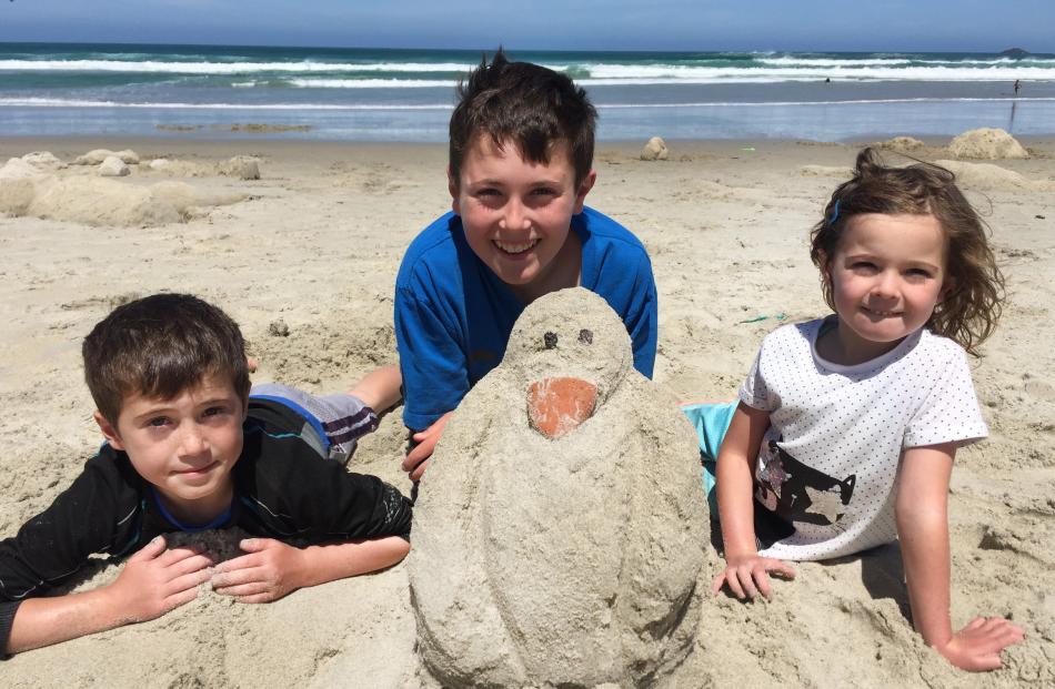 Lochie (8), Tyne (12) and Isla (6) Grant get ready to picnic with their penguin at the Forest and...