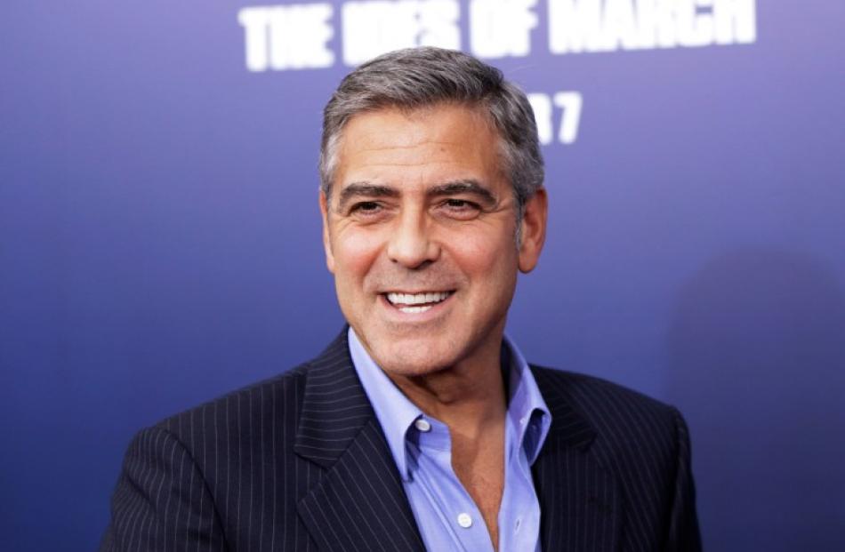 Director and cast member George Clooney smiles as he arrives for the premiere of his film 'The...
