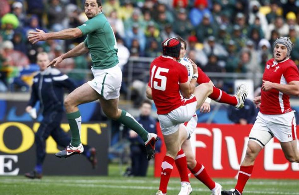 Wales' Leigh Halfpenny (centre) takes a high ball next to Ireland's Rob Kearney (left) during...