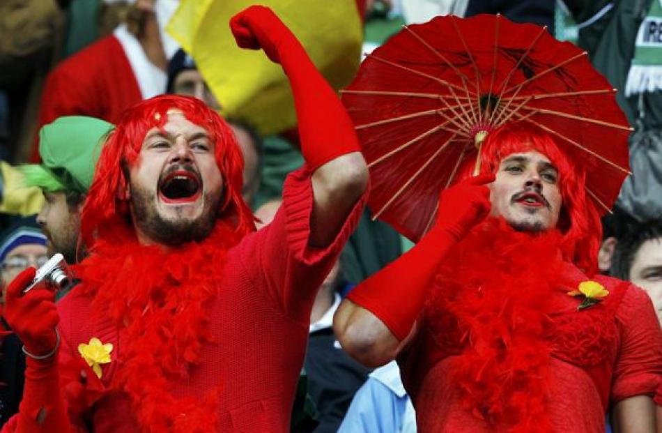 Wales supporters cheer before their Rugby World Cup quarter-final match against Ireland at...