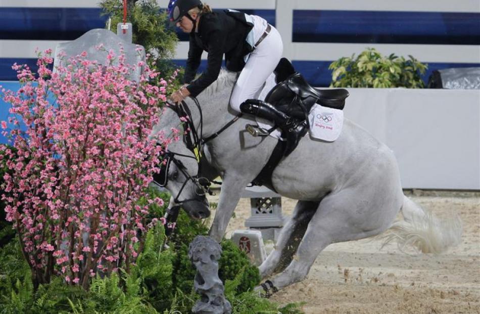 New Zealand rider Katie McVean goes over her horse Forest at fence during the first qualifying...