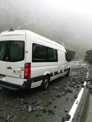 A German couple were on their way from Cascade Creek to Milford Sound in their hired camper van when the road began to disappear beneath flooding. Photo: Supplied
