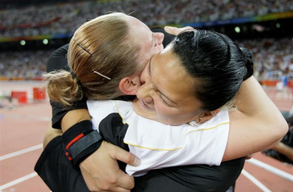 New Zealand's Valerie Vili, right, is congratulated by Germany's Nadine Kleinert after winning...