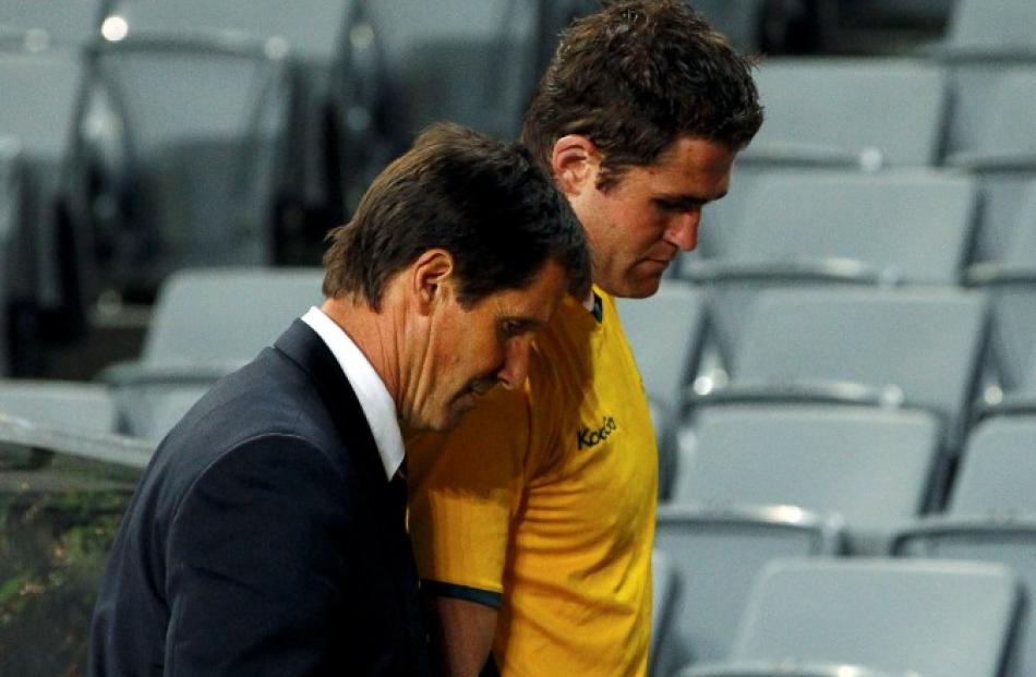Wallabies coach Robbie Deans and captain James Horwill leave the field after losing the match....
