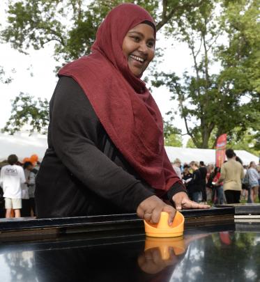 Plant bio-technology masters student Afreen A Saeed, of  Hamilton, plays air hockey.