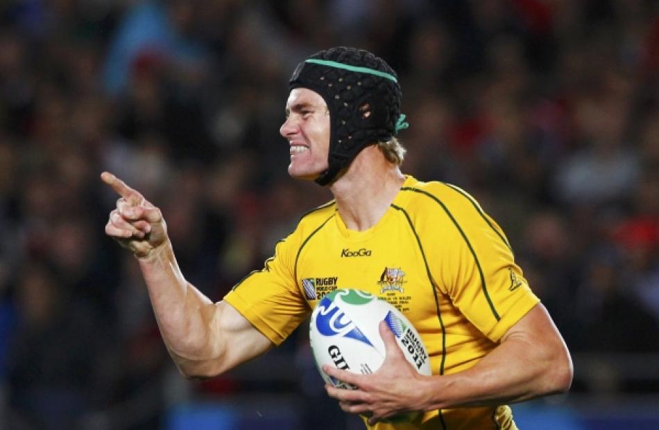 Australia Wallabies' Berrick Barnes celebrates after scoring a try against Wales during their...