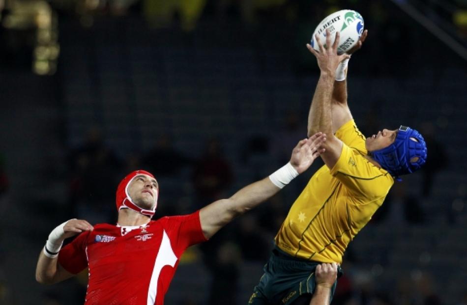 Australia Wallabies' Nathan Sharpe (right) takes a high ball from Wales' Luke Charteris during...