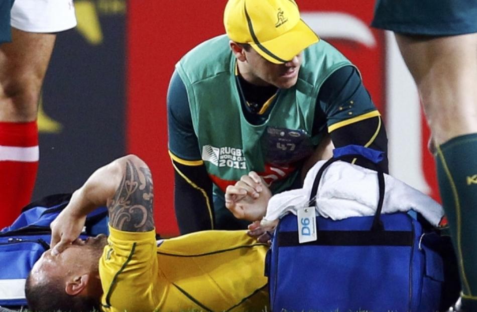 Australia Wallabies' Quade Cooper reacts after injuring his leg during their Rugby World Cup...