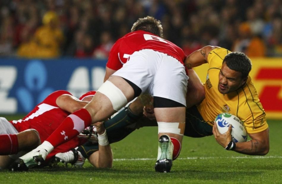 Wales' Danny Lydiate (centre) tackles Australia Wallabies' Digby Ioane (R) during their Rugby...
