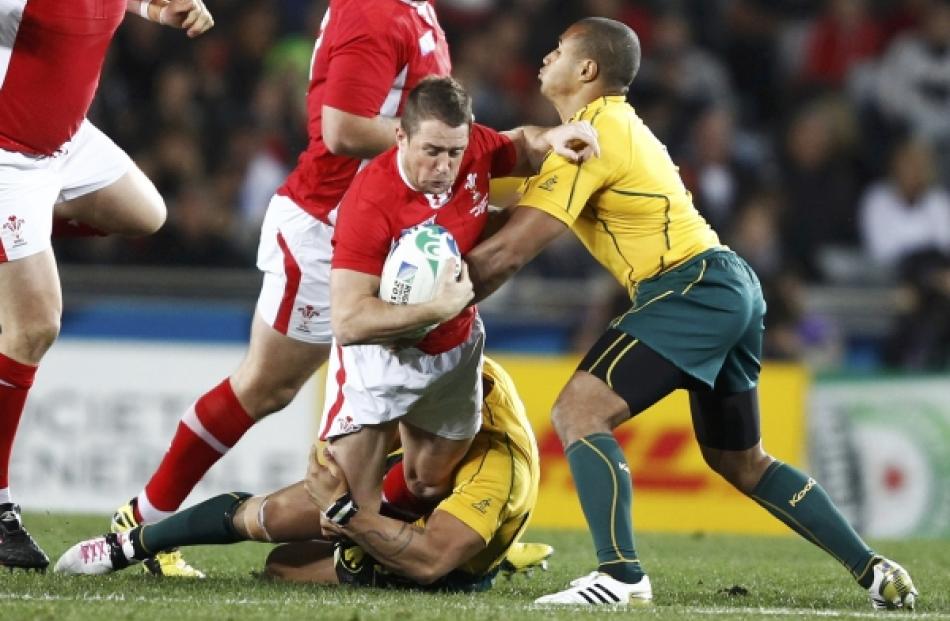 Wales' Mike Phillips is tackled by Australia Wallabies' Digby Ioane (on ground) during their...