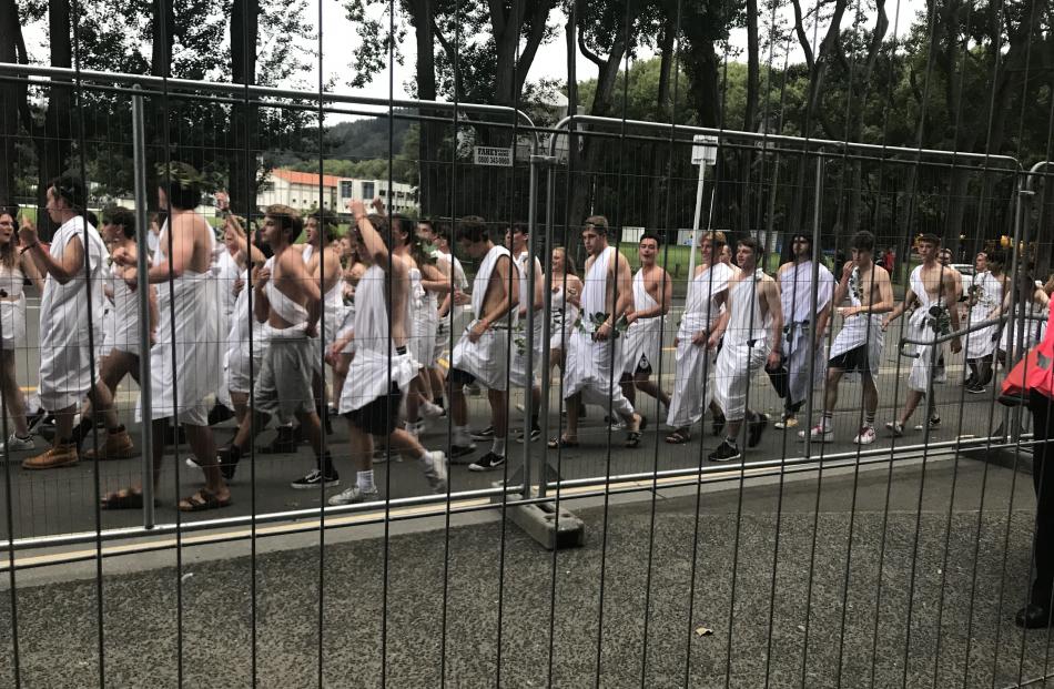 Students donning DIY togas on the street outside Fosyth Barr Stadium. Photo: Daisy Hudson