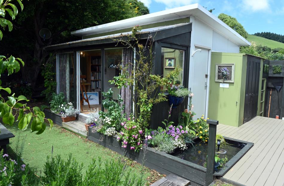 The art studio has sliding glass doors that open to the garden. 