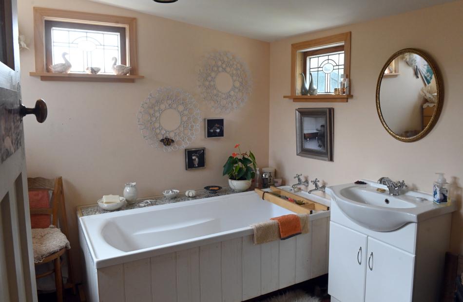 Still in its original location, the bathroom has been renovated. 