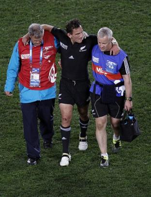 Aaron Cruden leaves the field injured.   (AP Photo/Dita Alangkara)