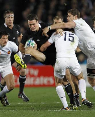 Richard Kahui is tackled by France's Maxime Medard. (AP Photo/Christophe Ena)