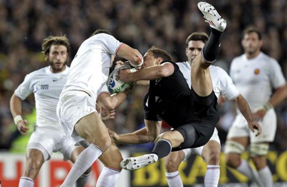 Israel Dagg and France's Maxime Mermoz compete to win the ball. (AP Photo/Themba Hadebe)