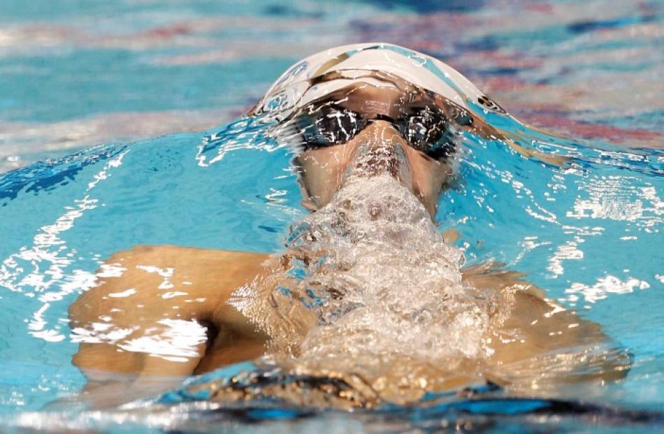 Michael Phelps of the US competes in the men's 100m individual medley qualifying event at the...