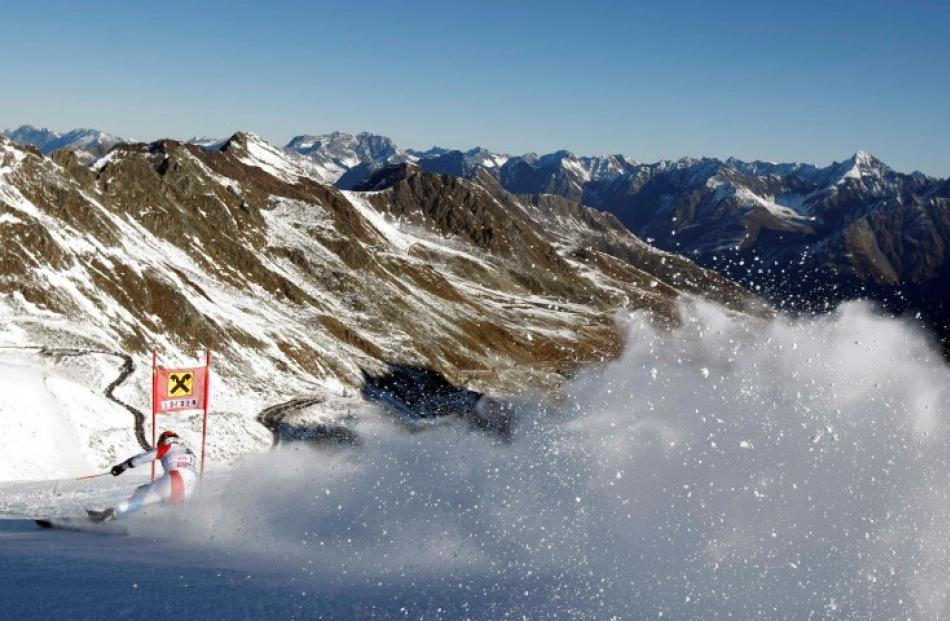 Didier Cuche of Switzerland clears a gate during the first run of the men's giant slalom World...