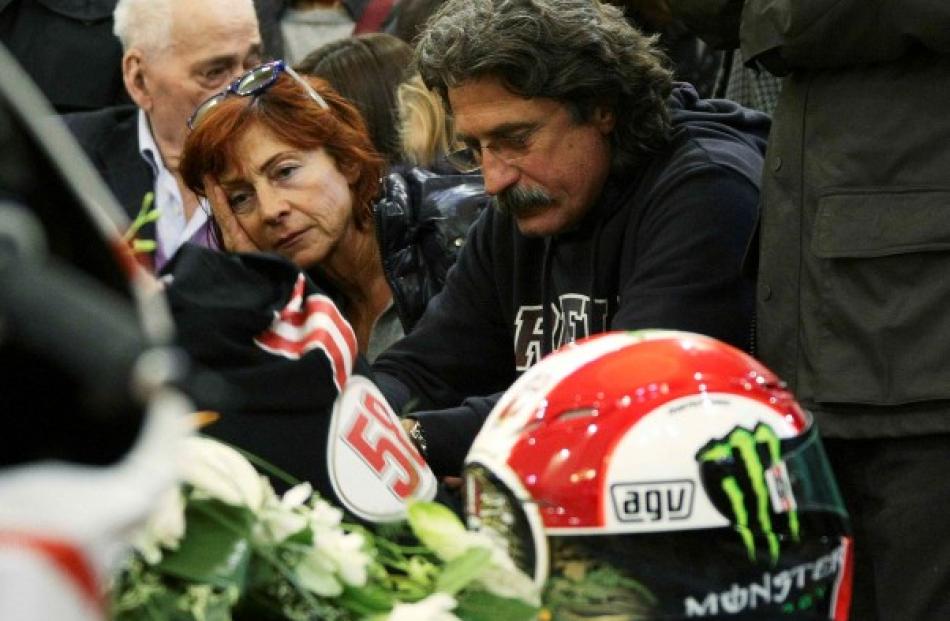 Paolo (R) and Rossella Simoncelli, the parents of Marco Simoncelli, attend the funeral service of...