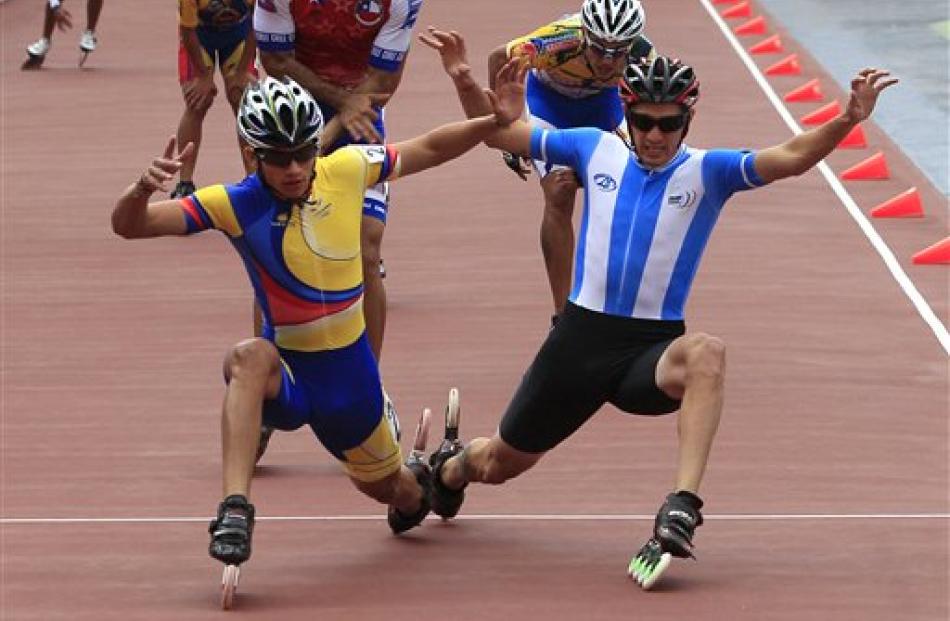 Colombia's Pedro Causil, left, and Argentina's Ezequiel Capellano cross the finish line during...