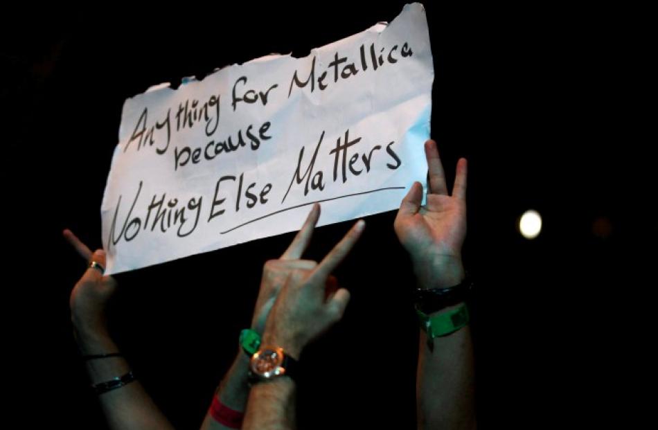 Fans hold up a poster during Metallica's World Magnetic tour concert in Abu Dhabi. REUTERS/Jumana...