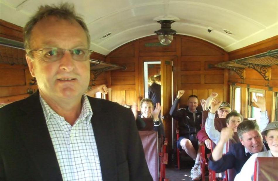 Kingston Flyer owner David Bryce enjoys the first ride of the day, in a carriage full of friends...