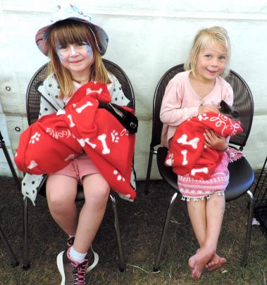 Ariah Ballantyne (5, left) and Sophie Balchin (6) snuggle up with rabbits in the Veterinary...