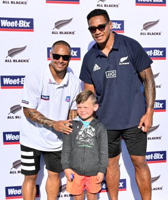 George McAlevey (6), of Abbotsford, poses with All Blacks Aaron Smith and Shannon Frizell.