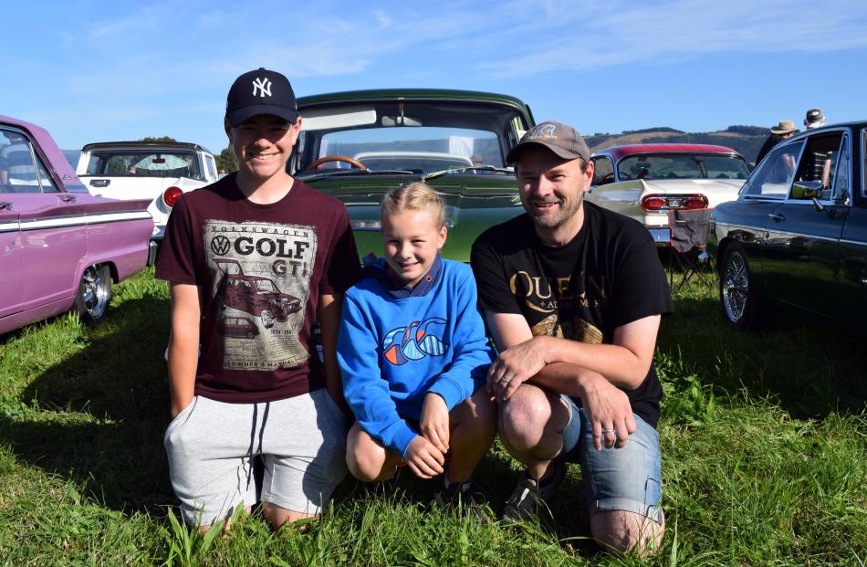 Devon (15), Ruby (11) and Mark Scott, all of Mosgiel, relax by a 1964 Ford Cortina GT 
...