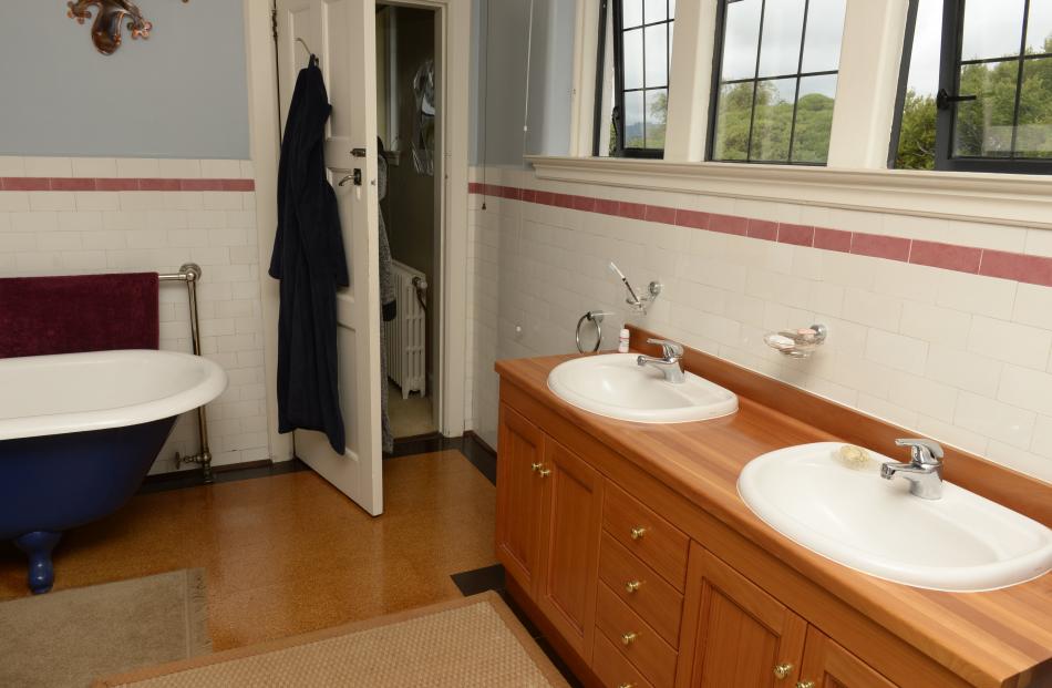 The ensuite was created from four small rooms. The bath and the pink tiles are both original. 
