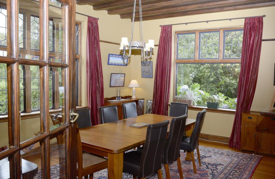 The dining room has a wood-panelled ceiling. 