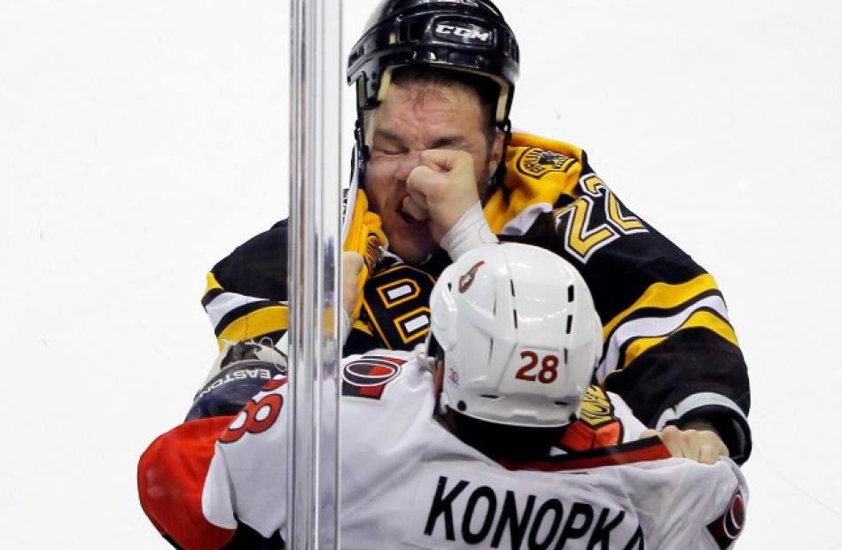 Boston Bruins right wing Shawn Thornton (top) and Ottawa Senators center Zenon Konopka fight in...