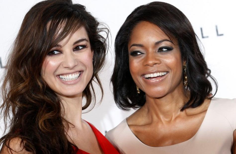 'Bond girls' Berenice Marlohe (L) and Naomie Harris pose 'SkyFall' production launch. REUTERS...