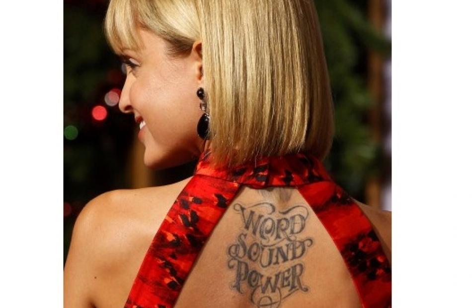 Actress Mena Suvari shows her tattooed back at the premiere of 'A Very Harold &amp; Kumar 3D...