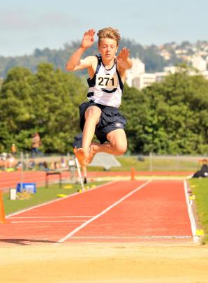 Tyler Clarke (14), of Otago Boys, gets airborne during the long jump. 