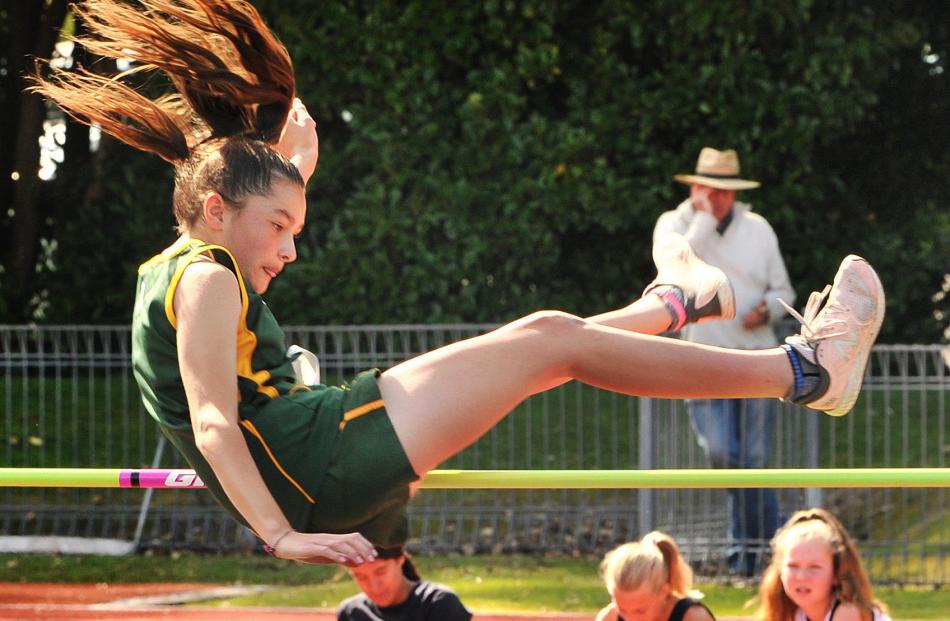 Kassia Barrett (13), of East Otago High, gets over the bar during a high jump event at the Otago...