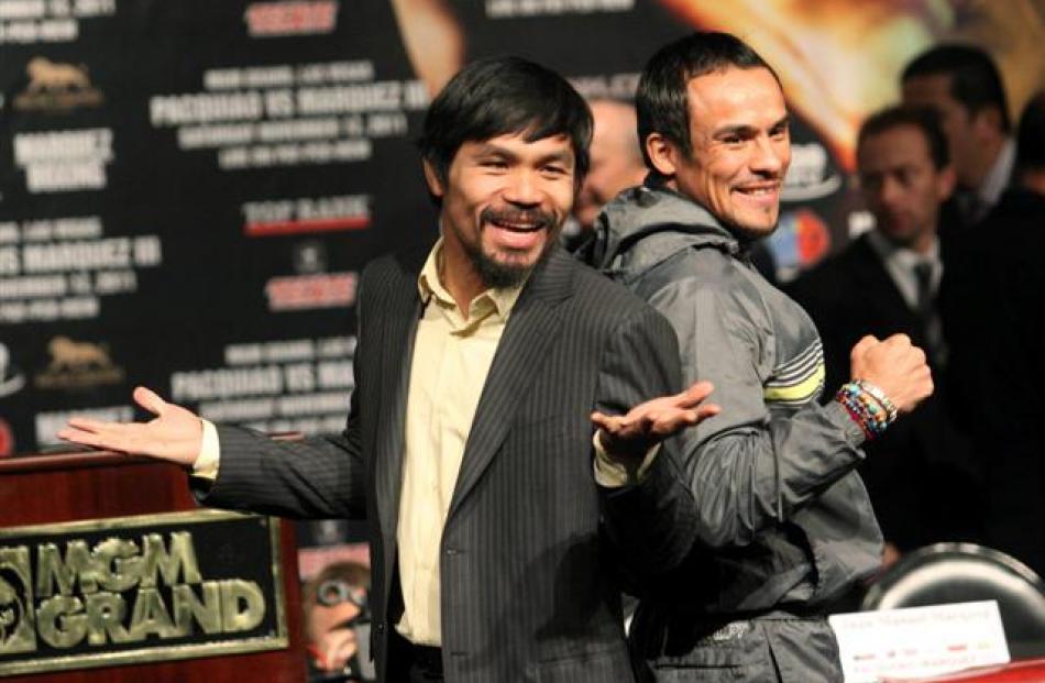 Filipino boxer Manny Pacquiao (L) and Mexican boxer Juan Manuel Marquez pose during a news...