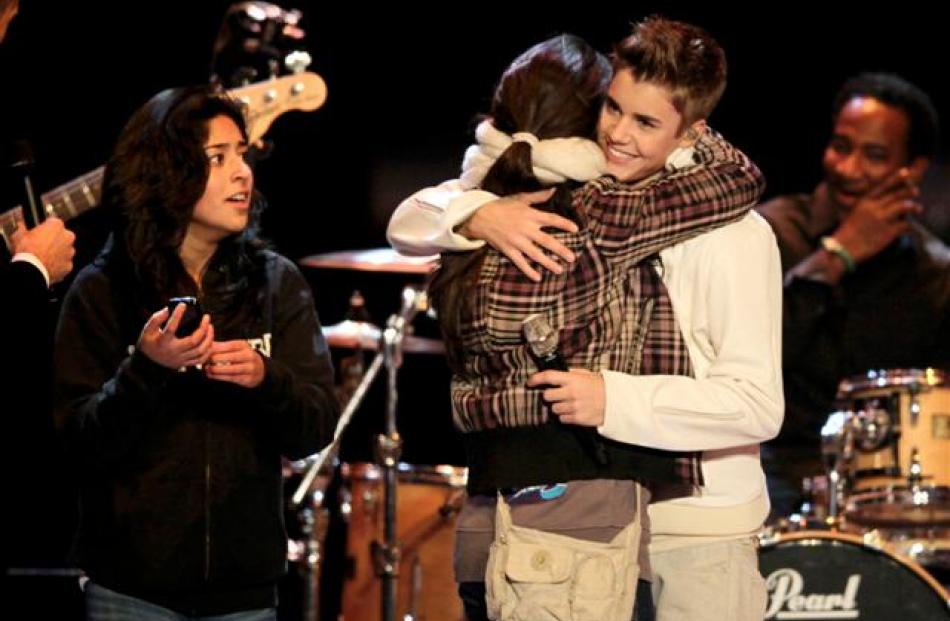 Canadian singer Justin Bieber embraces a fan after he performed during the 63rd Bambi media...