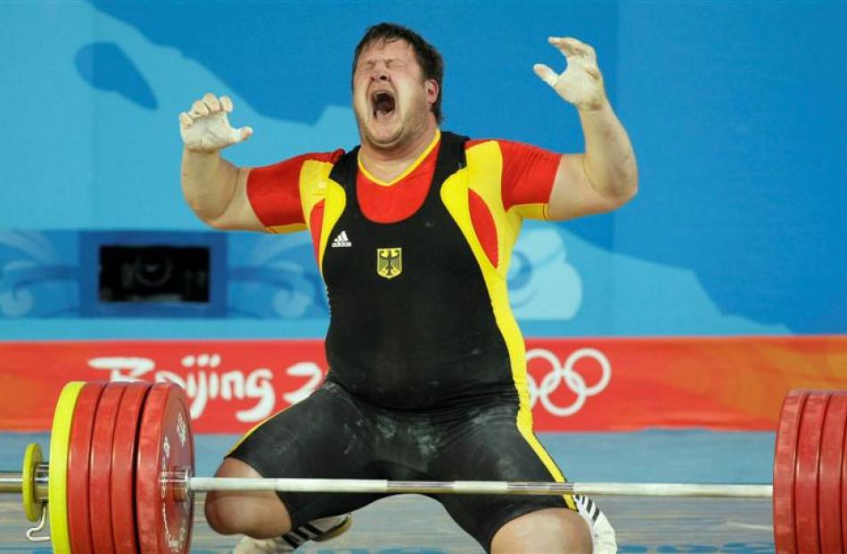 Matthias Steiner of Germany celebrates after winning gold in the men's +105 kg, weightlifting...