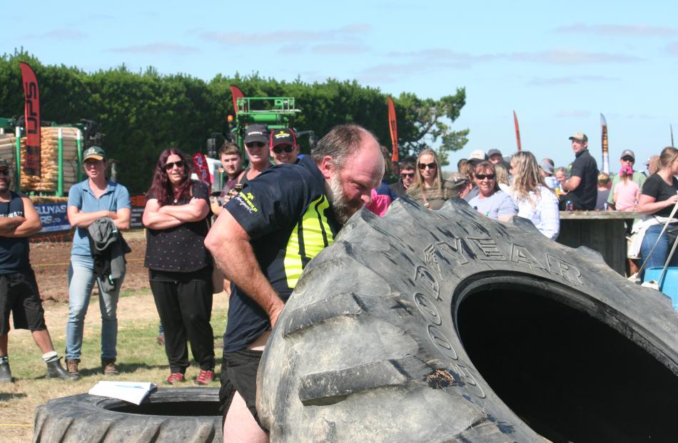 Darryl Sutton puts his all into a fun tractor tyre flipping event at the show.
