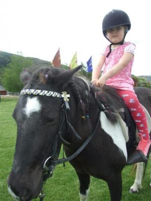 Isabelle Davis (4), of Arrowtown, goes for a trot with friend Cleo the pony.